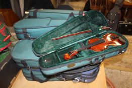 TWELVE CASED STUDENT TYPE VIOLINS