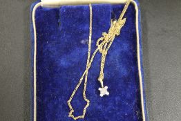 A HALLMARKED 10ct GOLD PENDANT AND CHAIN WITH DIAMOND CLUSTER