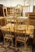 A MODERN ERCOL DRAWLEAF DINING TABLE AND SIX CHAIRS