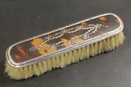 AN ANTIQUE SILVER AND PIQUE CLOTHES BRUSH