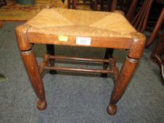 A SMALL OAK WICKER SEAT STOOL