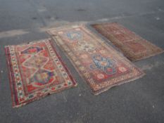THREE VINTAGE EASTERN WOOLLEN RUGS