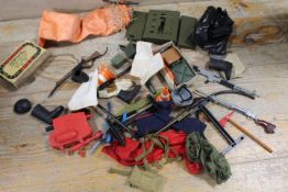 A TIN OF ASSORTED ACTION MAN CLOTHING ETC
