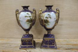 A PAIR OF LATE 19TH / EARLY 20TH CENTURY PORCELAIN VASES WITH LANDSCAPE CARTOUCHES