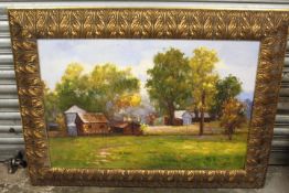 LARGE GILT FRAMED OIL ON CANVAS BUILDINGS IN A RURAL LANDSCAPE, SIGNED LOWER RIGHT