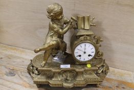 A GILT METAL MANTLE CLOCK WITH FIGURE OF GIRL READING A BOOK A/F