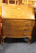 A REPRODUCTION WALNUT BUREAU ON CABRIOLE LEGS