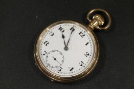 AN OPEN FACED MANUAL WIND GOLD PLATED POCKET WATCH