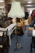 AN ART NOUVEAU BRASS LAMP STANDARD WITH A SHADE