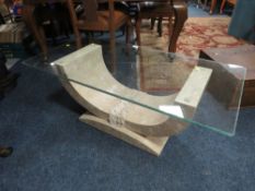 A MODERN GLASS TOPPED COFFEE TABLE