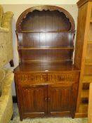 A CARVED OAK DUTCH STYLE DRESSER