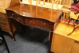A REPRODUCTION MAHOGANY SERPENTINE SHAPED CONSOLE TABLE