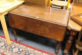 A 19TH CENTURY MAHOGANY DROPLEAF TABLE RAISED ON FLUTED SUPPORTS
