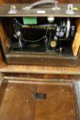 A CASED SINGER SEWING MACHINE - NUMBER EG008061