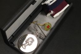 AN R.A.F. LONG SERVICE MEDAL WITH A PIN BADGE