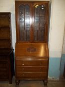 AN OAK BUREAU BOOKCASE