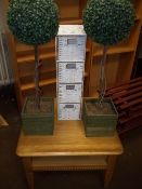 A MODERN OAK COFFEE TABLE AND WICKER STORAGE DRAWERS PLUS TWO ARTIFICIAL TREES