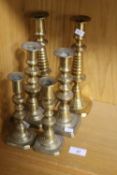 THREE PAIRS OF BRASS CANDLESTICKS LARGEST ONE 26CM