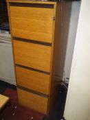 AN OAK FINISHED FOUR DRAWER FILING CABIENT