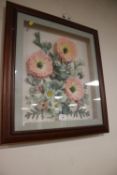 A FRAMED FLOWER DISPLAY UNDER GLASS
