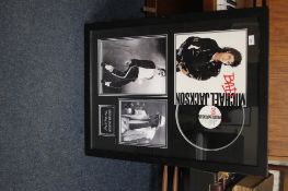 A MICHEAL JACKSON KING OF POP FRAMED PHOTOGRAPH AND A BAD ALBUM COVER AND VINYL