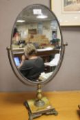 AN OVAL DRESSING TABLE MIRROR