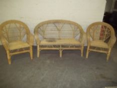 A CANE RATTAN THREE PIECE CONSERVATORY SUITE