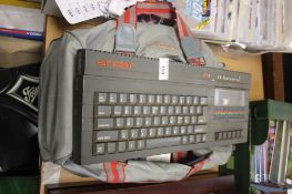 A SINCLAIR ZX SPECTRUM COMPUTER WITH A BAG OF GAMES