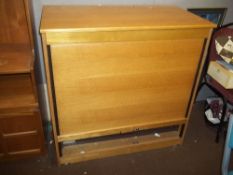 A MODERN OAK TYPE TAMBOUR STORAGE CUPBOARD