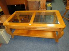 A MODERN GLASS TOPPED COFFEE TABLE W-129 CM