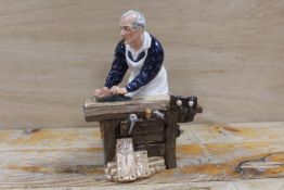 A ROYAL DOULTON FIGURE OF A CARPENTER