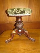 A VICTORIAN CARVED REVOLVING PIANO STOOL