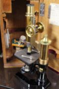 AN OAK CASED MICROSCOPE