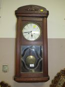 A MID 20TH CENTURY OAK CASED WALLCLOCK