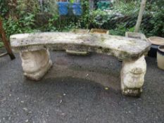 A CURVED CONCRETE GARDEN SEAT WITH LION PLINTHS
