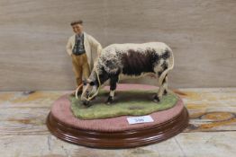 AN AYNSLEY FIGURE OF A FARMER WITH A LONGHORNED COW