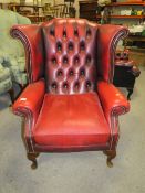 AN OXBLOOD RED LEATHER CLASSICAL WINGBACK ARMCHAIR