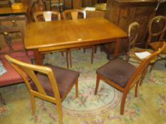 A RETRO NATHAN EXTENDING TEAK TABLE AND FOUR CHAIRS