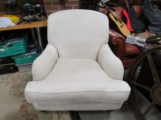 A MODERN UPHOLSTERED ARMCHAIR