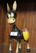 A VINTAGE WOODEN MONEY BOX IN THE SHAPE OF A DONKEY