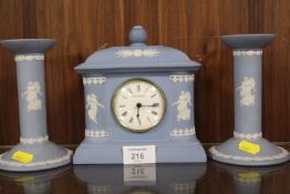 A WEDGWOOD BLUE JASPERWARE DANCING HOURS MANTLE CLOCK AND GARNITURE SET