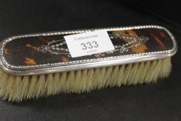AN ANTIQUE SILVER AND PIQUE CLOTHES BRUSH