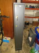 A DOUBLE LOCK GUN CABINET WITH KEYS