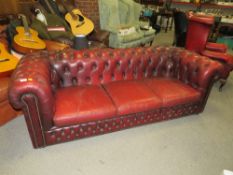 AN OXBLOOD RED LEATHER CHESTERFIELD