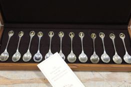 A SET OF 12 SOLID SILVER R.S.P.B. SPOONS IN PRESENTATION CASE