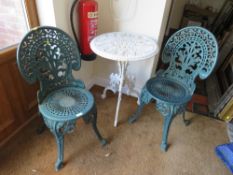 TWO HEAVY CAST PAINTED CHAIRS AND A WHITE TABLE