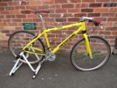 A CANNONDALE CAD3 24 SPEED MOUNTAIN BIKE WITH CYCLE TRAINER