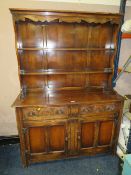 A VINTAGE OAK CARVED WELSH STYLE DRESSER W-128 CM