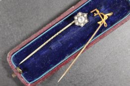 A STICK PIN WITH RIDING CROP AND STIRRUP FINIAL TOGETHER WITH ANOTHER (2)
