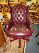 A REPRODUCTION LEATHER EFFECT SWIVEL OFFICE ARMCHAIR